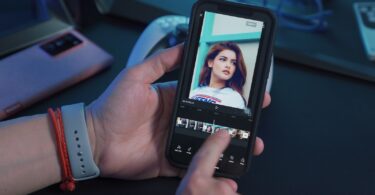 a person holding a cell phone with a picture of a woman on the screen